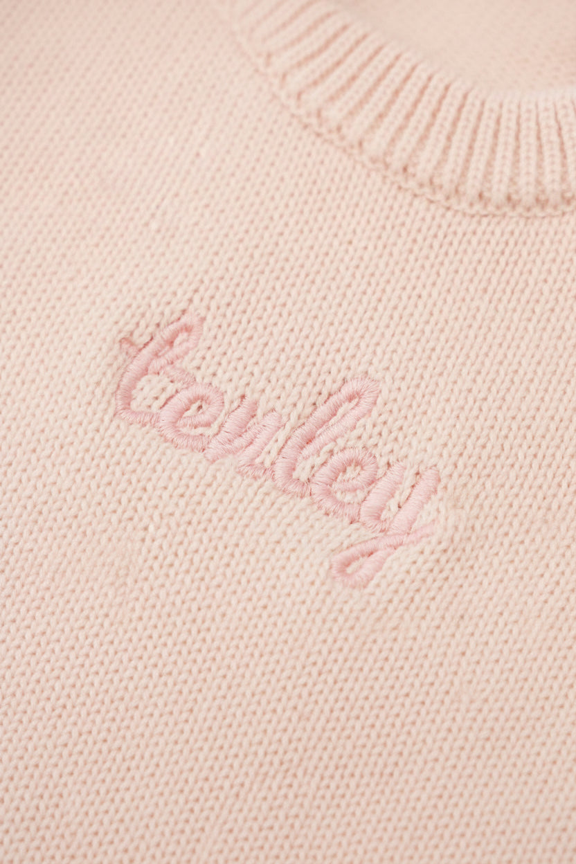 tea rose long sleeve knit sweater romper with light pink thread in script font 