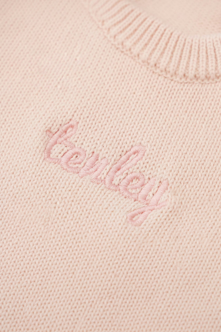 tea rose long sleeve knit sweater romper with light pink thread in script font 