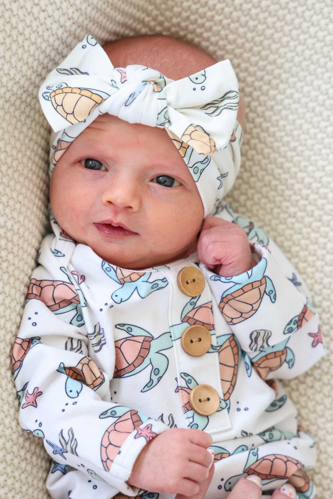 alternate view of knit large bow headwrap with turtle print in bamboo
