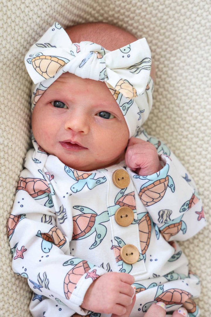 alternate view of knit large bow headwrap with turtle print in bamboo
