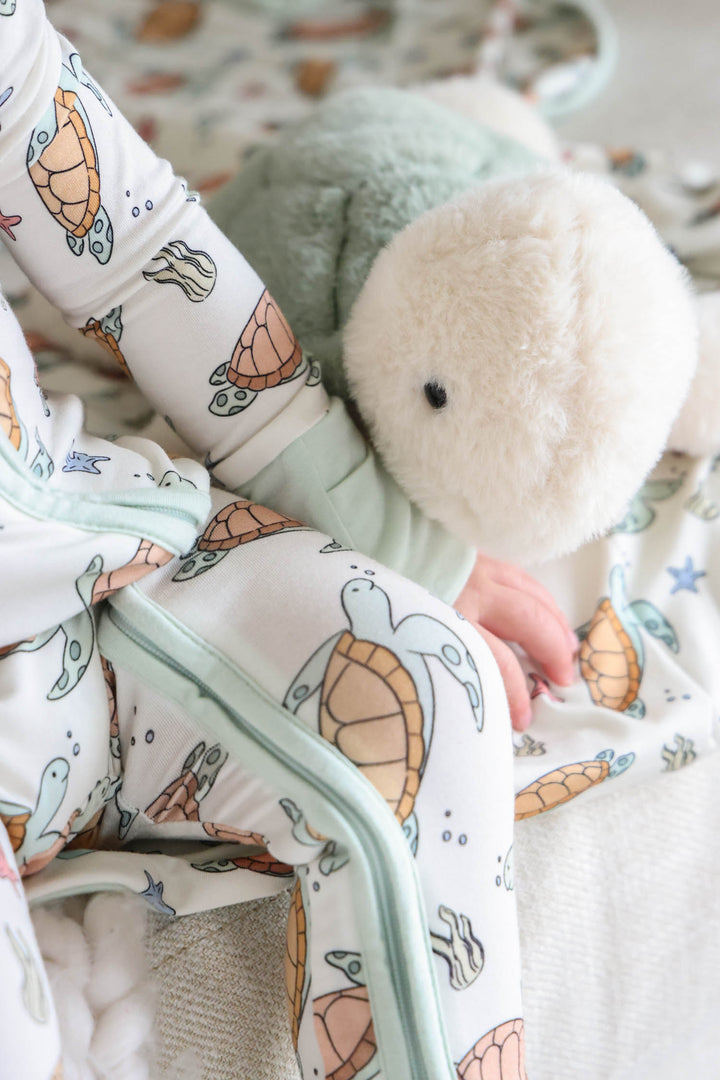 turtley rad bamboo convertible zip romper on a baby – gender neutral turtle print