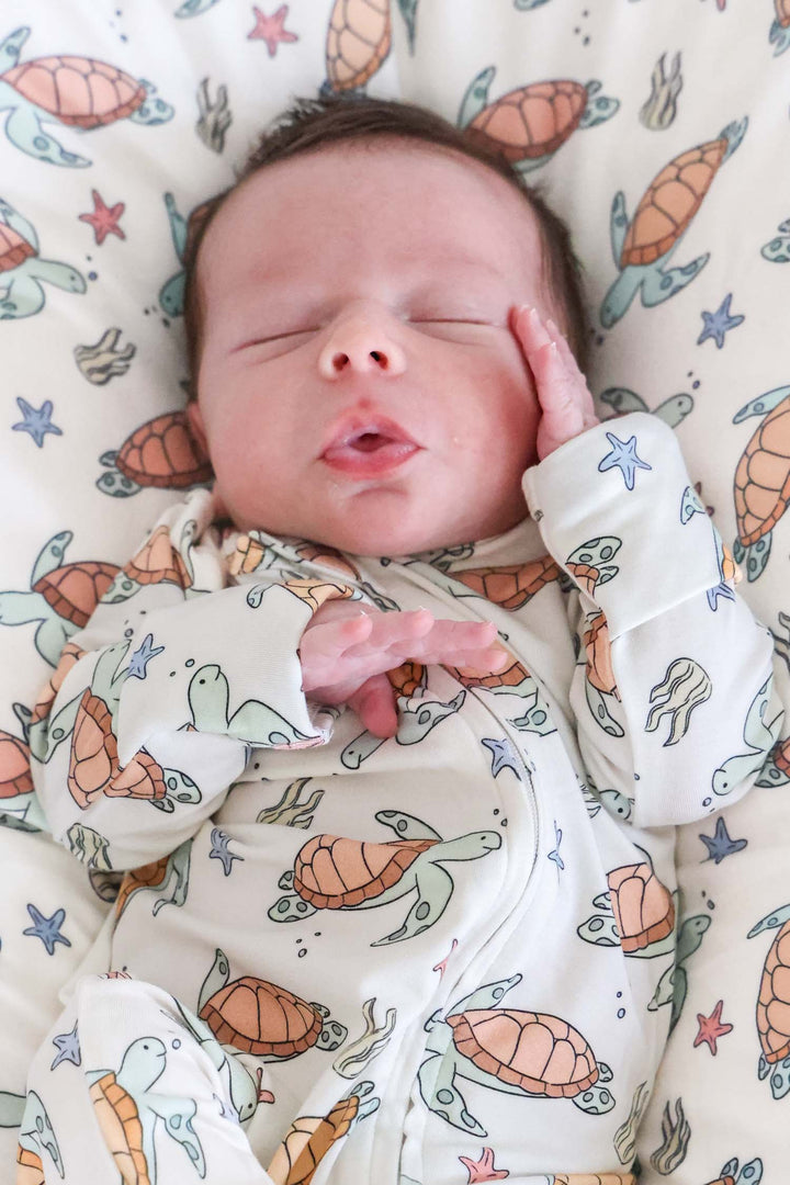 turtley rad bamboo one-piece footie on a baby – gender neutral turtle print