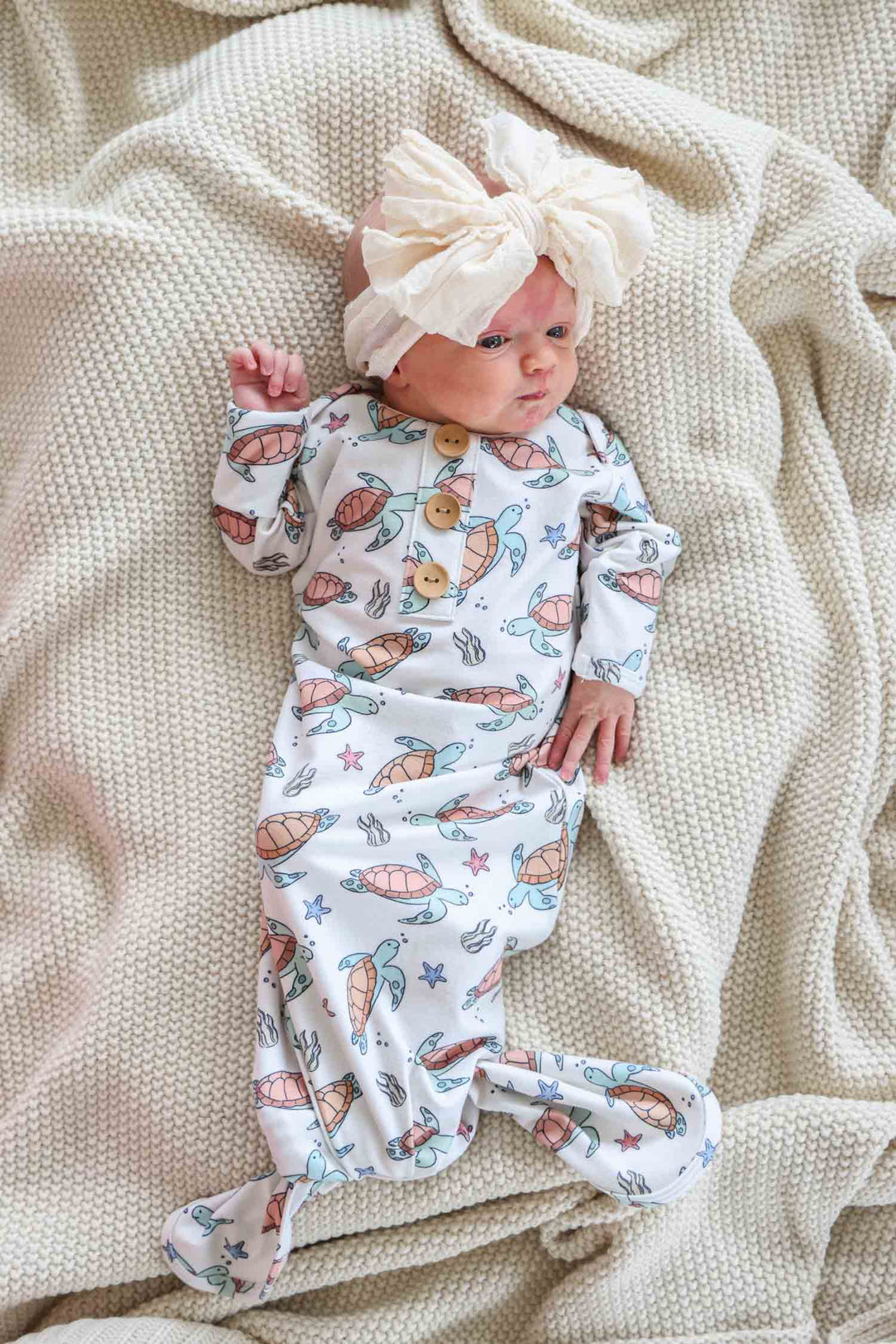 turtley rad bamboo knot gown on a baby – gender neutral turtle print
