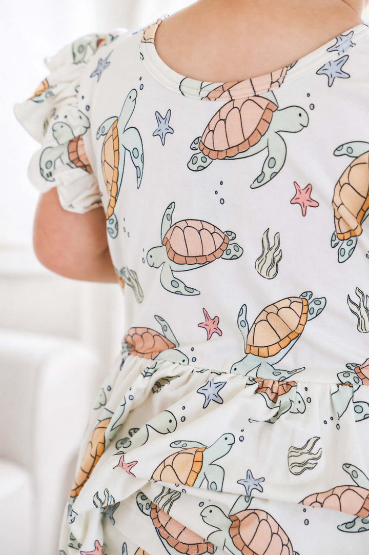 baby wearing turtley rad bamboo smocked twirl one piece – turtle print sleepwear for little ones