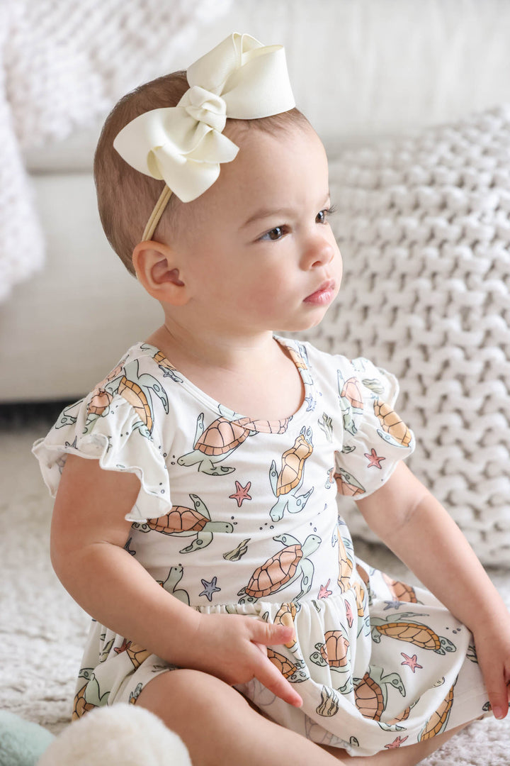 turtley rad bamboo smocked twirl one piece on a baby – gender neutral turtle print