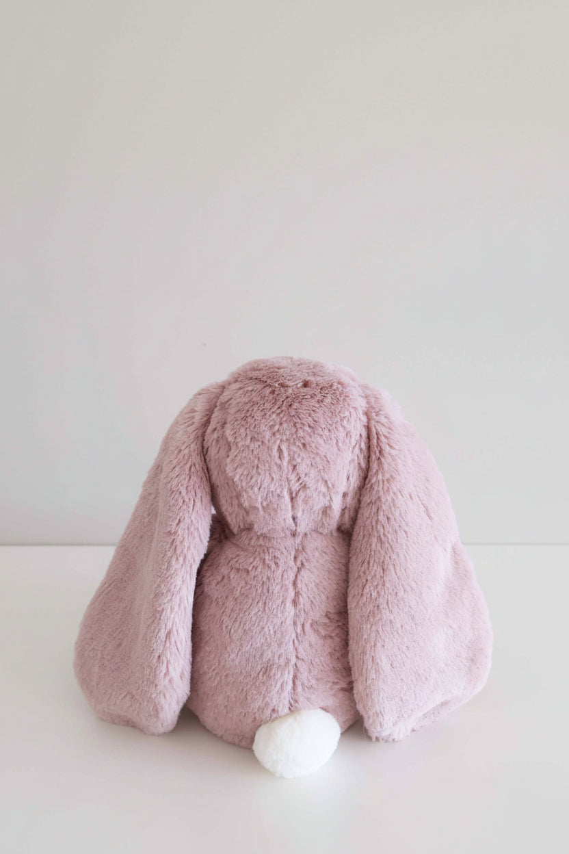 violet bunny stuffed animal with white fluffy tail
