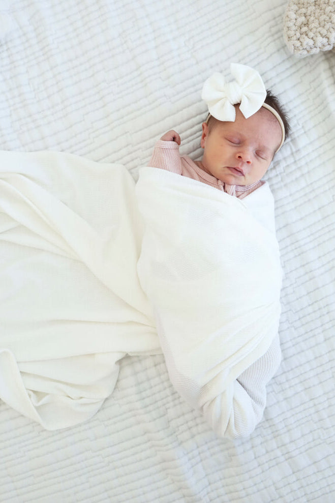 white bamboo waffle swaddle and bow headband 