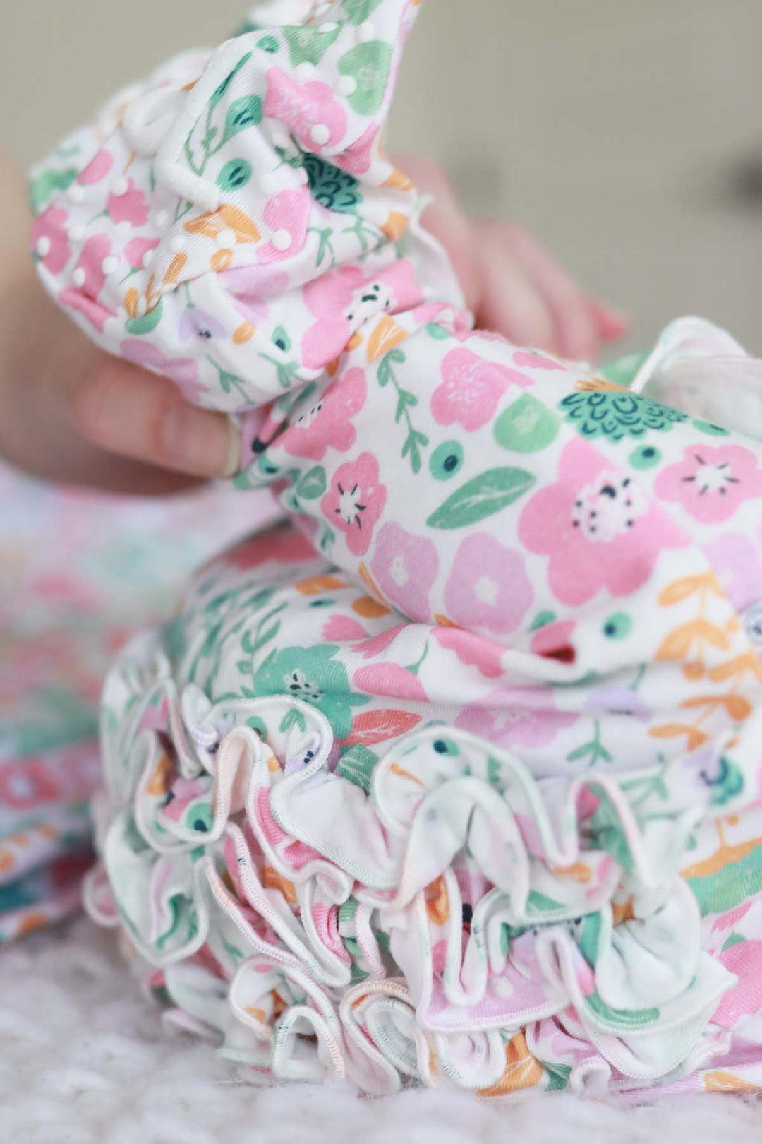 multicolor flower baby footie with ruffle on the butt 